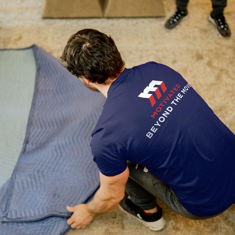 Motivated Movers professionals unpack and arrange items in a new residence, providing stress-free moving assistance.