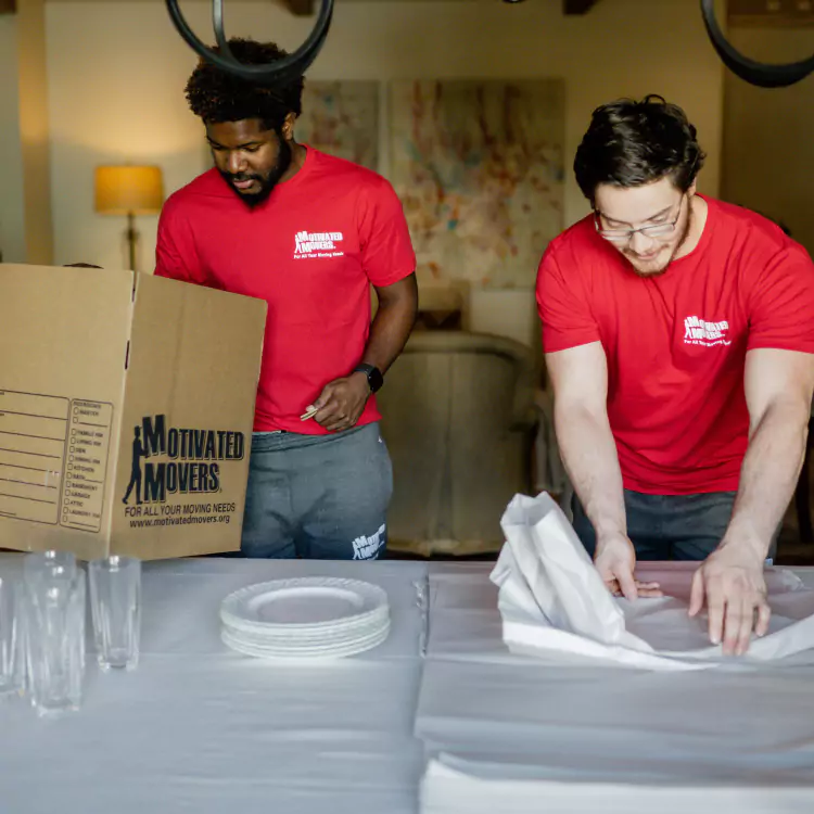 Motivated Movers professionals unpack and arrange items in a new residence, providing stress-free moving assistance.