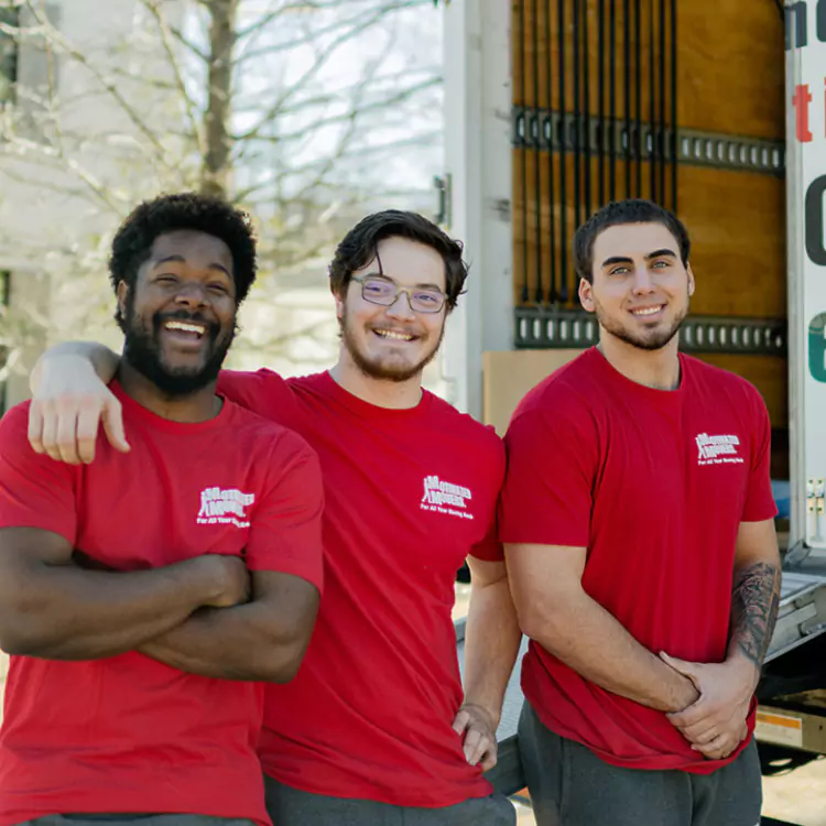 A friendly Motivated Movers crew poses together, symbolizing teamwork and reliable moving services.