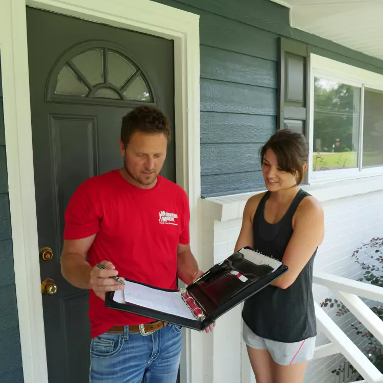 A Motivated Movers specialist reviews moving details with a homeowner, offering personalized moving consultation.