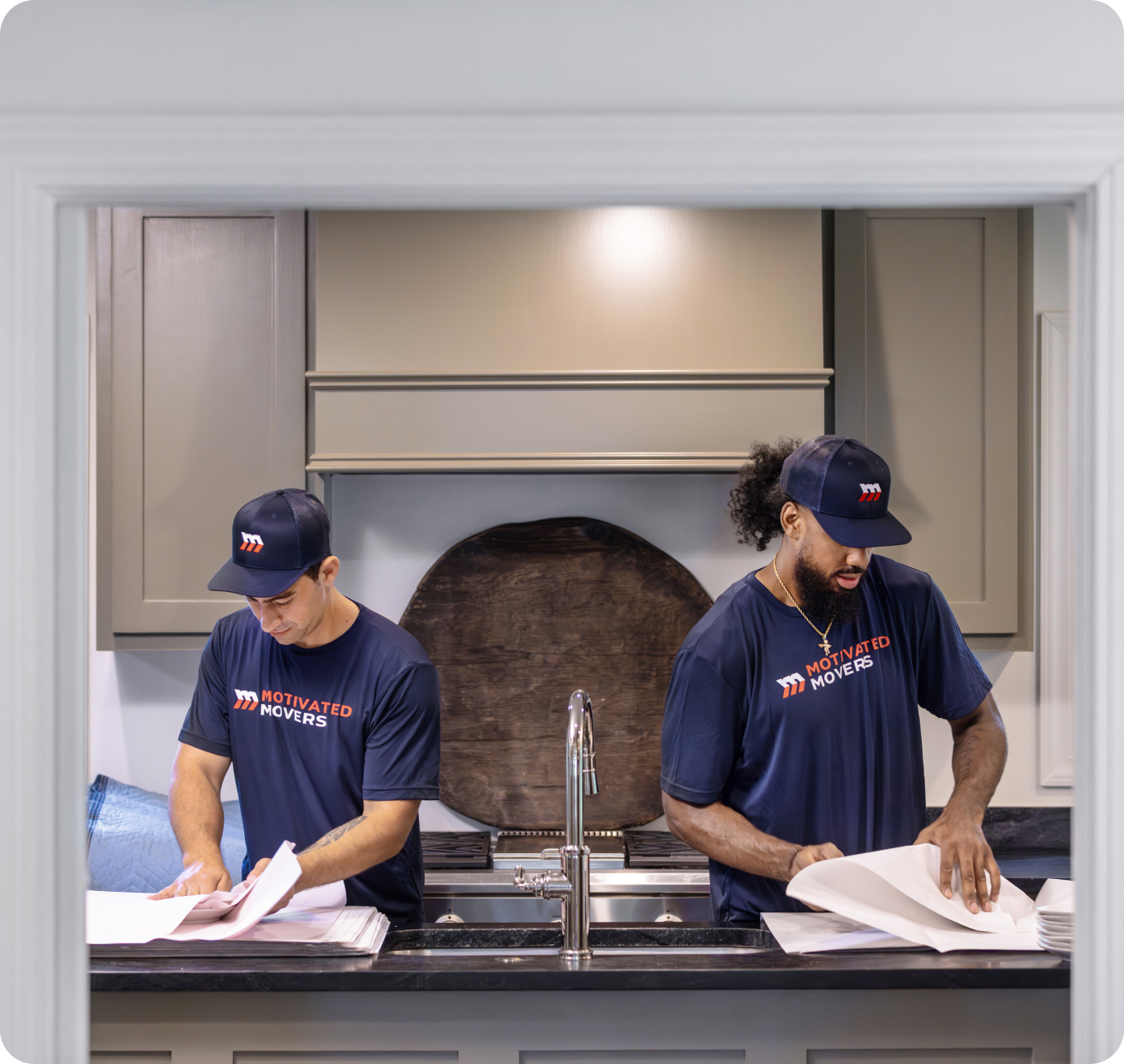 Motivated Movers packing in the kitchen.