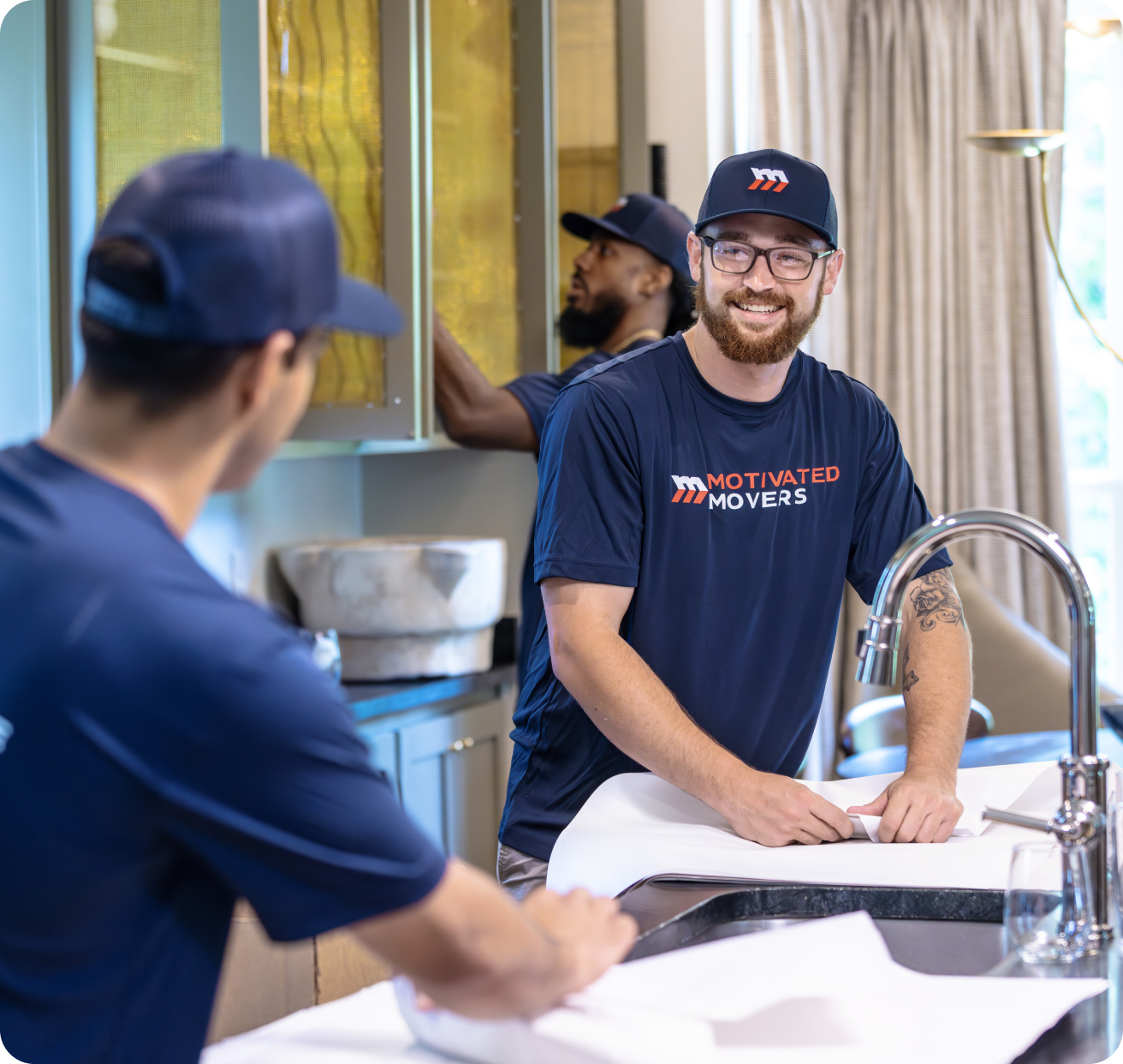 Motivated Movers packing in the kitchen.